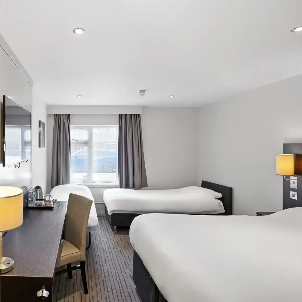 A modern hotel room with two twin beds